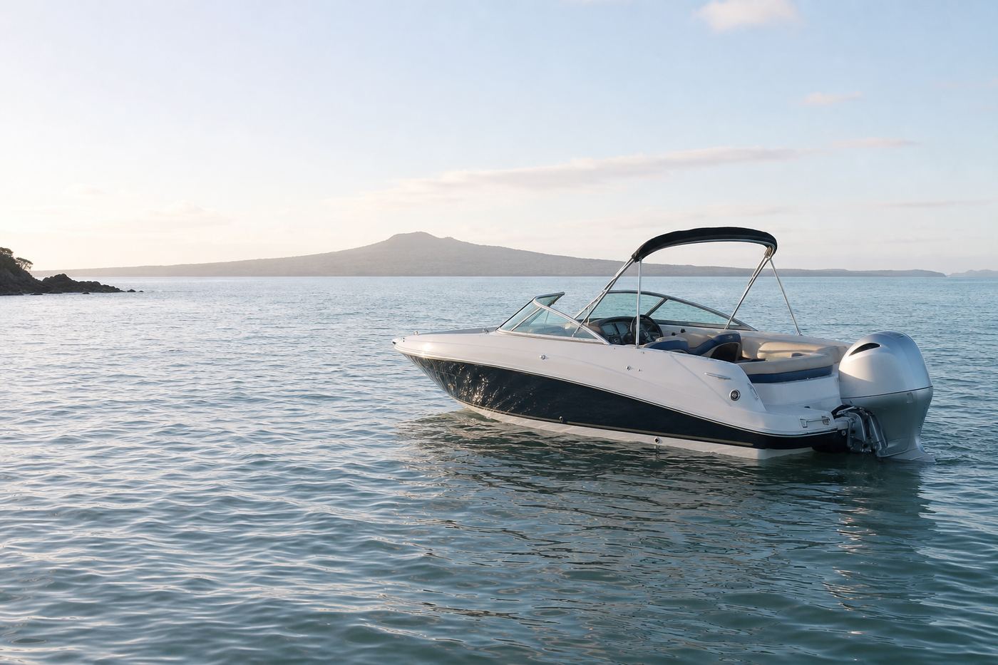 Powerboat on Auckland harbour with Rangitoto beyond